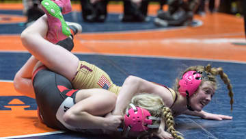 Loyola Academy’s Harlee Hiller, top, takes down Mt. Zion’s Sydney Cannon in the 115-pound final of the girls high school state wrestling championships Saturday, March 1, 2025 at Grossinger Motors Arena in Bloomington. Hiller took the title with a 12-0 major decision.