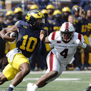 Sep 14, 2024; Ann Arbor, Michigan, USA;  Michigan Wolverines quarterback Alex Orji (10) runs the ball against the Arkansas State Red Wolves during the second half at Michigan Stadium. Mandatory Credit: Rick Osentoski-Imagn Images