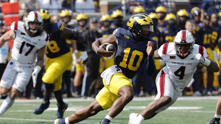 Sep 14, 2024; Ann Arbor, Michigan, USA;  Michigan Wolverines quarterback Alex Orji (10) runs the ball against the Arkansas State Red Wolves during the second half at Michigan Stadium. Mandatory Credit: Rick Osentoski-Imagn Images