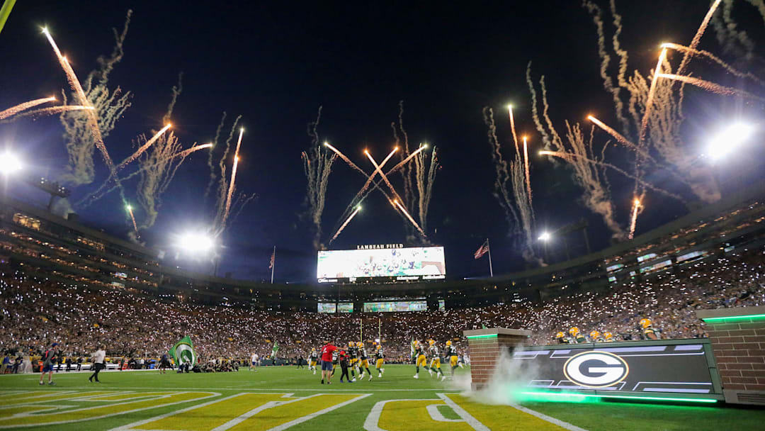 Fireworks are fired off as the Green Bay Packers run out of the tunnel before a game.
