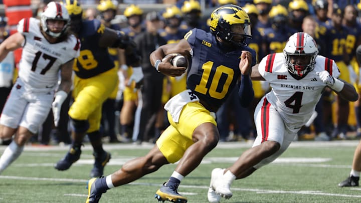 Sep 14, 2024; Ann Arbor, Michigan, USA;  Michigan Wolverines quarterback Alex Orji (10) runs the ball against the Arkansas State Red Wolves during the second half at Michigan Stadium. Mandatory Credit: Rick Osentoski-Imagn Images