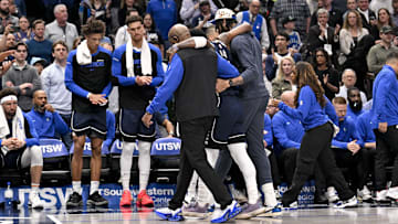 Mar 3, 2025; Dallas, Texas, USA; Dallas Mavericks guard Kyrie Irving (11) is helped off the court by forward Anthony Davis (3) during the second quarter against the Sacramento Kings at the American Airlines Center. Mandatory Credit: Jerome Miron-Imagn Images