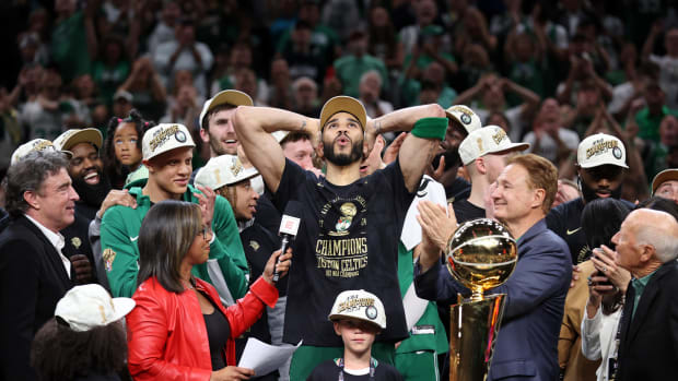 Celtics star Jayson Tatum puts his hands on his head, looks up to the sky, and exhales after winning his first NBA title.