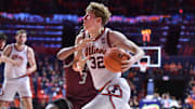 Nov 25, 2024; Champaign, Illinois, USA;  Illinois Fighting Illini guard Kasparas Jakucionis (32) drives against Little Rock Trojans guard Isaiah Lewis (3) during the first half at State Farm Center. Mandatory Credit: Ron Johnson-Imagn Images