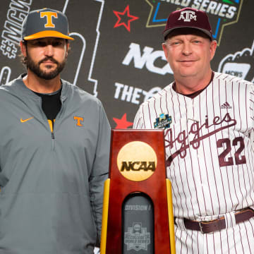 Tennessee head coach Tony Vitello and Texas A&M head coach Jim Schlossnagle pose for a photo with the championship trophy during a press conference before the NCAA College World Series finals at Charles Schwab Field in Omaha, Neb., on Friday, June 21, 2024.