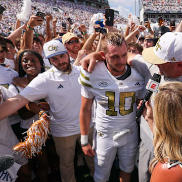 Sep 13, 2025; Atlanta, Georgia, USA; Georgia Tech Yellow Jackets quarterback Haynes King (10) and head coach Brent Key talk to a reporter after a victory over the Clemson Tigers at Bobby Dodd Stadium at Hyundai Field. Mandatory Credit: Brett Davis-Imagn Images