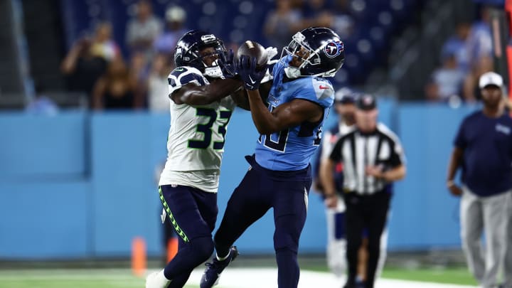 Aug 17, 2024; Nashville, Tennessee, USA; Tennessee Titans wide receiver Bryce Oliver (80) has a catch blocked by Seattle Seahawks wide receiver Dee Williams (33) late in the fourth quarter at Nissan Stadium. Mandatory Credit: Casey Gower-USA TODAY Sports