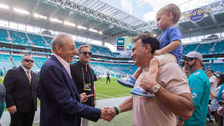 Miami Dolphins owner Stephen Ross shakes hands with sports agent Drew Rosenhaus on the sidelines prior to the start of the football game between the New York Jets and host Miami Dolphins at Hard Rock Stadium on Sunday, January 8, 2023, in Miami Gardens, FL.