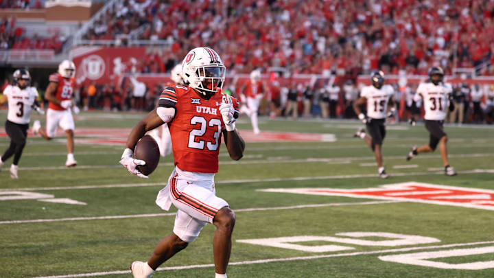 Aug 29, 2024; Salt Lake City, Utah, USA; Utah Utes running back Dijon Stanley (23) runs for a touchdown after a catch against the Southern Utah Thunderbirds during the second quarter at Rice-Eccles Stadium. 