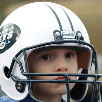 Oct 25, 2014; London, UNITED KINGDOM; A child wears a New York Jets helmet at the NFL Fan Rally at Trafalgar Square in advance of the International Series game between the Detroit Lions and the Atlanta Falcons. Mandatory Credit: Kirby Lee-Imagn Images