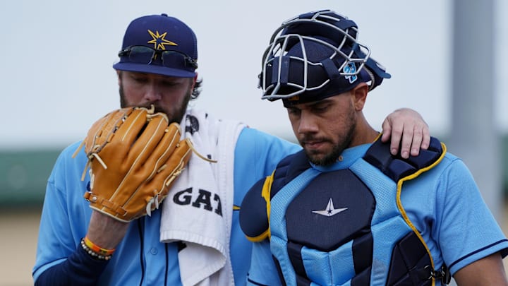 Mar 11, 2023; Jupiter, Florida, USA;  Tampa Bay Rays relief pitcher Josh Fleming (19) and catcher Rene Pinto (50) talk before the game against he Miami Marlins at Roger Dean Stadium. Mandatory Credit: Jim Rassol-Imagn Images