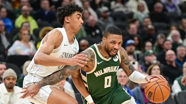 Mar 5, 2025; Milwaukee, Wisconsin, USA; Milwaukee Bucks guard Damian Lillard (0) drives for the basket against Dallas Mavericks guard Max Christie (00) in the first quarter at Fiserv Forum. Mandatory Credit: Benny Sieu-Imagn Images