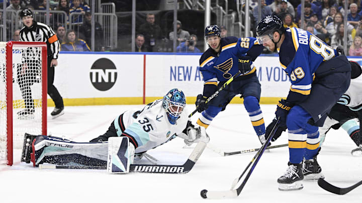 Apr 14, 2024; St. Louis, Missouri, USA; Seattle Kraken goaltender Joey Daccord (35) defends the net from St. Louis Blues left wing Pavel Buchnevich (89) during the second period at Enterprise Center. Mandatory Credit: Jeff Le-Imagn Images