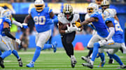 New Orleans Saints running back Kendre Miller (25) runs past Los Angeles Chargers safety Derwin James Jr. (3)