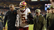 Washington Commanders quarterback Jayden Daniels exits Sunday night's game against the Seahawks.