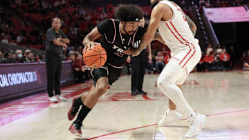 Troy Trojans guard Tayton Conerway (12) drives against Houston Cougars guard Emanuel Sharp (21) in the first half at Fertitta Center.