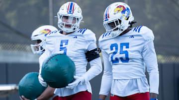 Kansas redshirt senior defensive end Dean Miller (5) works alongside redshirt freshman defensive end Caleb Redd (25) during a spring practice on April 11, 2025.