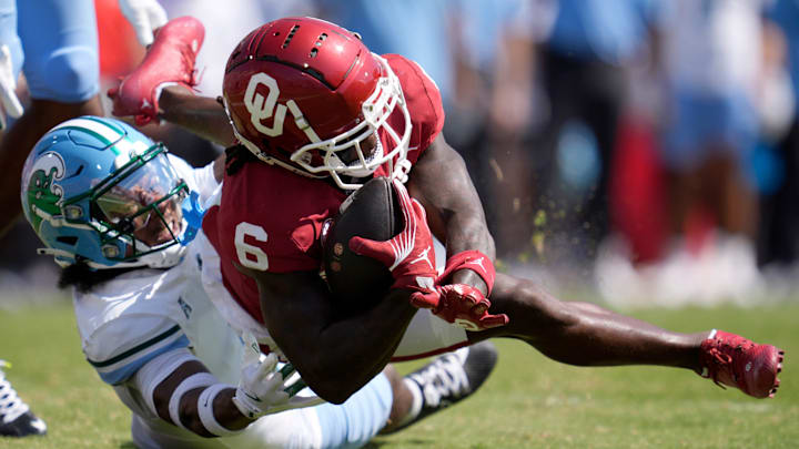 Oklahoma Sooners wide receiver Deion Burks (6) catches a pass in front of of Tulane Green Wave safety Caleb Ransaw (7) during a college football game between the University of Oklahoma Sooners (OU) and the Tulane Green Wave at Gaylord Family - Oklahoma Memorial Stadium in Norman, Okla., Saturday, Sept. 14, 2024.