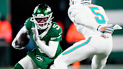 New York Jets wide receiver Garrett Wilson (5) runs with the ball as he tries to find a way past Miami Dolphins cornerback Jalen Ramsey (5), Sunday January 5, 2025, in East Rutherford.