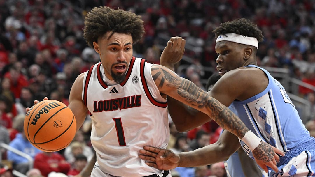 Jan 1, 2025; Louisville, Kentucky, USA;  Louisville Cardinals guard J'Vonne Hadley (1) dribbles against North Carolina Tar Heels forward Ven-Allen Lubin (22) during the second half at KFC Yum! Center. Mandatory Credit: Jamie Rhodes-Imagn Images