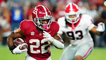 Sep 28, 2024; Tuscaloosa, Alabama, USA;  Alabama Crimson Tide running back Justice Haynes (22) runs the ball against Georgia Bulldogs defensive lineman Tyrion Ingram-Dawkins (93) during the fourth quarter at Bryant-Denny Stadium. Mandatory Credit: John David Mercer-Imagn Images