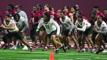 Florida State football players Sione Lolohea (13), Patrick Payton (11) and Marvin Jones Jr. (7) take