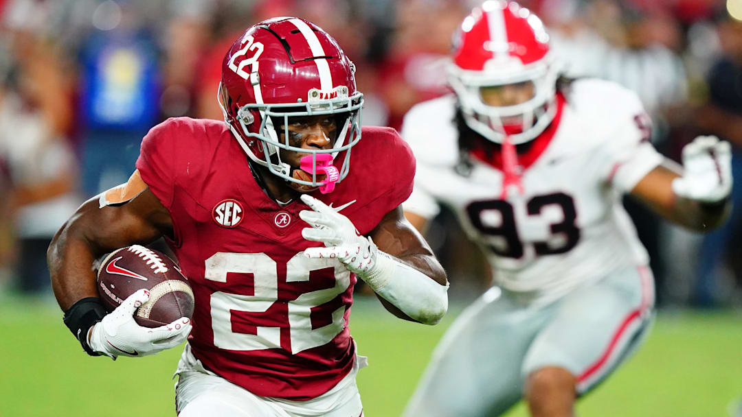 Sep 28, 2024; Tuscaloosa, Alabama, USA;  Alabama Crimson Tide running back Justice Haynes (22) runs the ball against Georgia Bulldogs defensive lineman Tyrion Ingram-Dawkins (93) during the fourth quarter at Bryant-Denny Stadium. Mandatory Credit: John David Mercer-Imagn Images