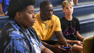 Alabama quarterback Jalen Milroe plays the new EA Sports College Football 25 video game at the McDonald Hughes Center in Tuscaloosa. Milroe is one of the players featured on the game’s cover.