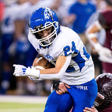 Dike-New Hartford's Devon Lotts (24) is brought down after a catch on Thursday, Nov. 21, 2024, at the UNI-Dome in Cedar Falls, IA.