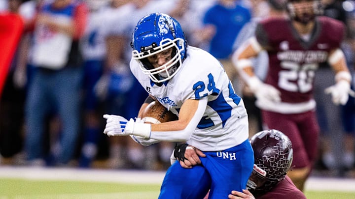 Dike-New Hartford's Devon Lotts (24) is brought down after a catch on Thursday, Nov. 21, 2024, at the UNI-Dome in Cedar Falls, IA.
