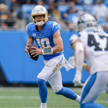 Sep 15, 2024; Charlotte, North Carolina, USA;  Los Angeles Chargers quarterback Justin Herbert (10) looks for a receiver against the Carolina Panthers during the second half at Bank of America Stadium. Mandatory Credit: Jim Dedmon-Imagn Images