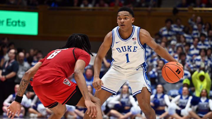 Jan 27, 2025; Durham, North Carolina, USA; Duke basketball guard Caleb Foster (1) dribble against North Carolina State Wolfpack guard Jayden Taylor (8) during the second half at Cameron Indoor Stadium.  The Blue Devils won 74-64.
