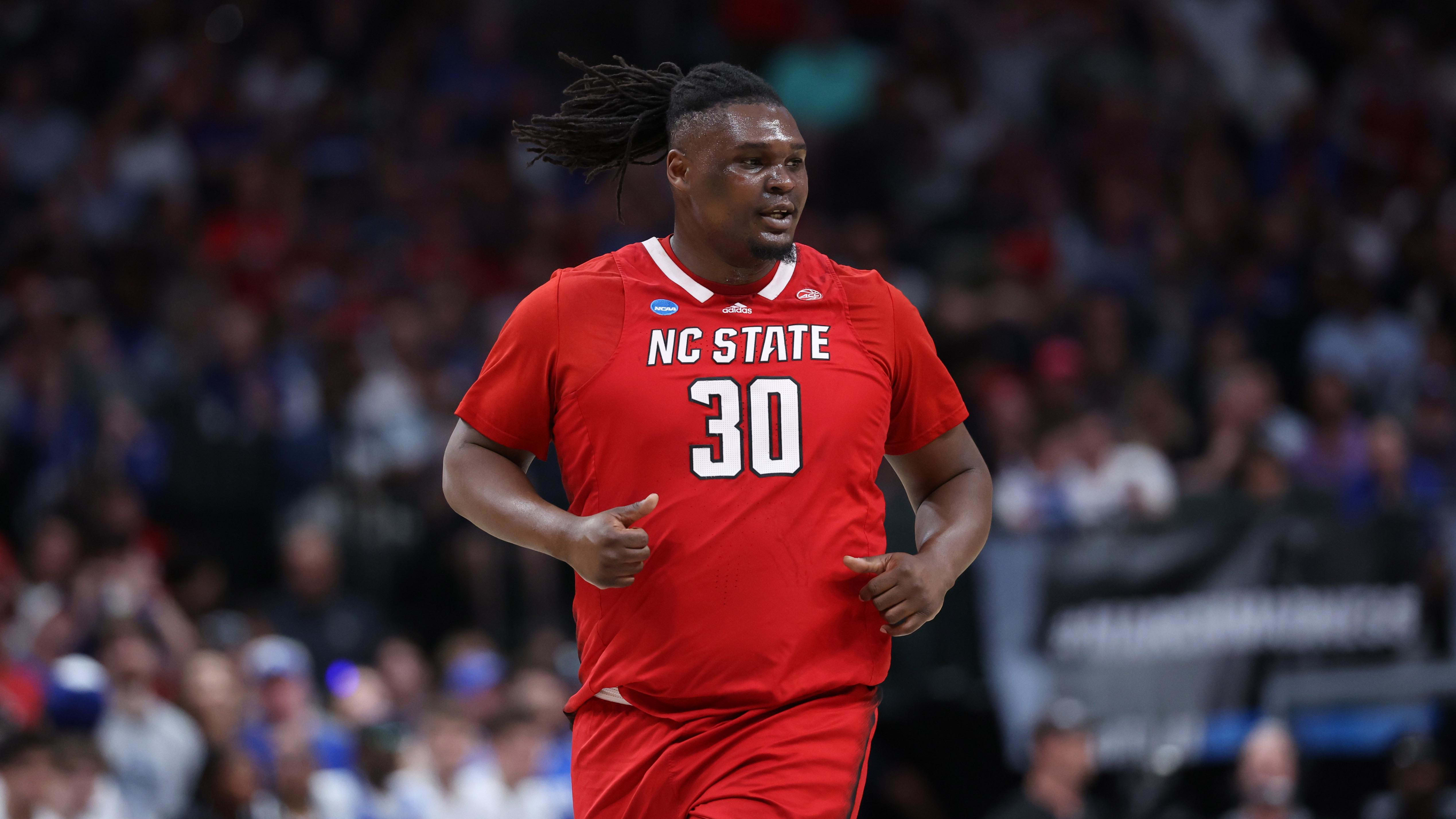 NC State basketball player DJ Burns Jr. jogs down the court.