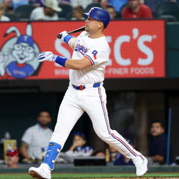 Jul 2, 2024; Arlington, Texas, USA;  Texas Rangers first baseman Nathaniel Lowe (30) hits a two-run home run during the first inning against the San Diego Padres at Globe Life Field. Mandatory Credit: Kevin Jairaj-USA TODAY Sports