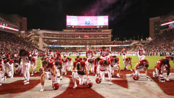 Nov 18, 2023; Fayetteville, Arkansas, USA; Arkansas Razorbacks players take a knee prior to the game against the FIU Panthers at Donald W. Reynolds Razorback Stadium. Arkansas won 44-20. Mandatory Credit: Nelson Chenault-USA TODAY Sports