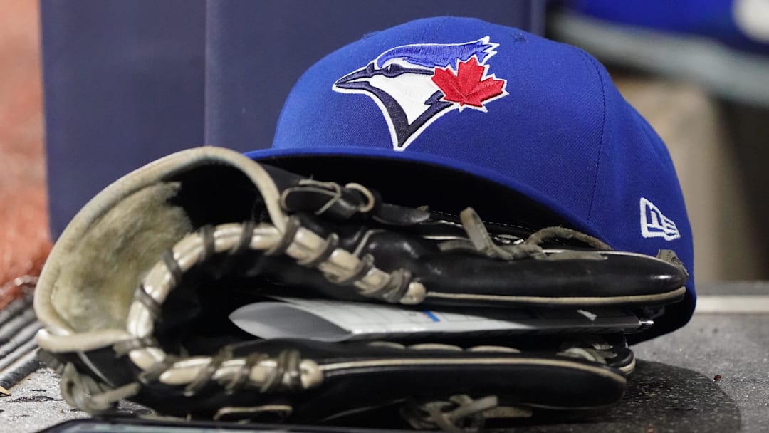 A Toronto Blue Jays cap and glove sits in the dugout during a game against the Arizona Diamondbacks at Rogers Centre. A Toronto Blue Jays cap and glove sits in the dugout during a game against the Arizona Diamondbacks at Rogers Centre.