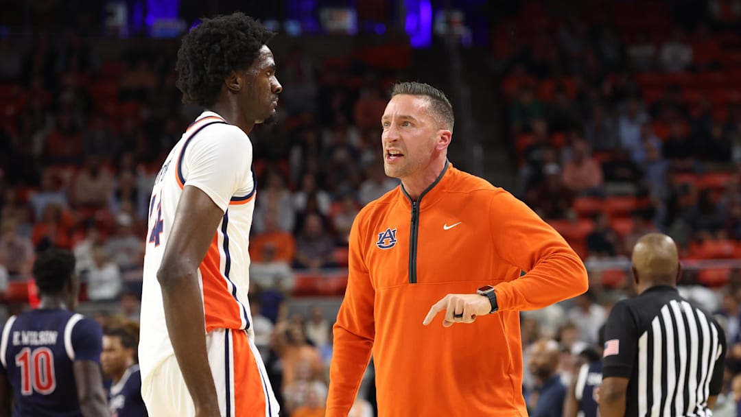 Auburn Tigers head coach Steven Pearl speaks with center Emeka Opurum (14)