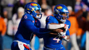 Nov 19, 2022; Lawrence, Kansas, USA; Kansas Jayhawks running back Devin Neal (4) takes the handoff from quarterback Jalon Daniels (6) during the first half against the Texas Longhorns at David Booth Kansas Memorial Stadium. Mandatory Credit: Jay Biggerstaff-USA TODAY Sports