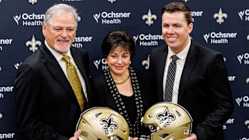 Feb 13, 2025; New Orleans, LA, USA;  New Orleans Saints owner Gayle Benson and general manager Mickey Loomis pose with the new head coach Kellen Moore at Ochsner Sports Performance Center. Mandatory Credit: Stephen Lew-Imagn Images