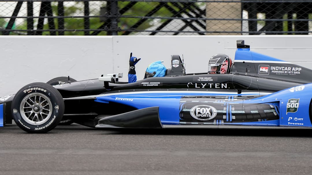 Jimmie Johnson drives a two-seater with Tom Brady on Sunday, May 25, 2025, during the 109th running of the Indianapolis 500 at Indianapolis Motor Speedway.