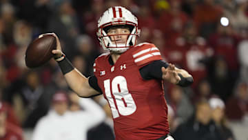 Nov 16, 2024; Madison, Wisconsin, USA;  Wisconsin Badgers quarterback Braedyn Locke (18) throws a pass during the second quarter against the Oregon Ducks at Camp Randall Stadium. Mandatory Credit: Jeff Hanisch-Imagn Images