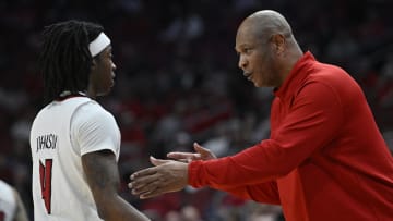 Mar 2, 2024; Louisville, Kentucky, USA; Louisville Cardinals head coach Kenny Payne talks with guard Ty-Laur Johnson (4) during the first half against the Syracuse Orange at KFC Yum! Center. Mandatory Credit: Jamie Rhodes-USA TODAY Sports