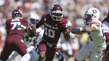Sep 27, 2025; College Station, Texas, USA; Texas A&M Aggies quarterback Marcel Reed (10) runs with the ball as Auburn Tigers safety Eric Winters (25) attempts to make a tackle during the first quarter at Kyle Field. Mandatory Credit: Troy Taormina-Imagn Images