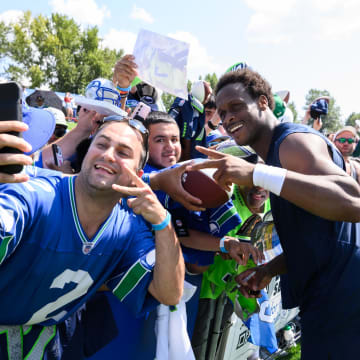 Jul 30, 2023; Renton, WA, USA; Seattle Seahawks quarterback Geno Smith (7) takes a selfie with fans after practice at the Virginia Mason Athletic Center. Mandatory Credit: Steven Bisig-USA TODAY Sports