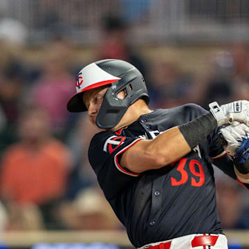 Jul 22, 2024; Minneapolis, Minnesota, USA; Minnesota Twins third baseman Diego A. Castillo (39) hits a ground rule double against the Philadelphia Phillies in the fifth inning at Target Field. Mandatory Credit: Jesse Johnson-Imagn Images