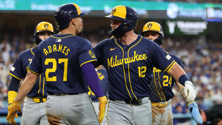 Jul 5, 2024; Los Angeles, California, USA;  Milwaukee Brewers first baseman Rhys Hoskins (12) is greeted by shortstop Willy Adames (27) after hitting a grand slam during the fourth inning against the Los Angeles Dodgers at Dodger Stadium. Mandatory Credit: Kiyoshi Mio-USA TODAY Sports