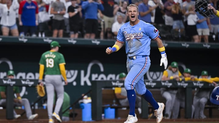 Sep 1, 2024; Arlington, Texas, USA; Texas Rangers third baseman Josh Jung (6) celebrates after he hits a game winning three run walk-off home run during the tenth inning off of Oakland Athletics relief pitcher Mason Miller (19) at Globe Life Field. Mandatory Credit: Jerome Miron-USA TODAY Sports