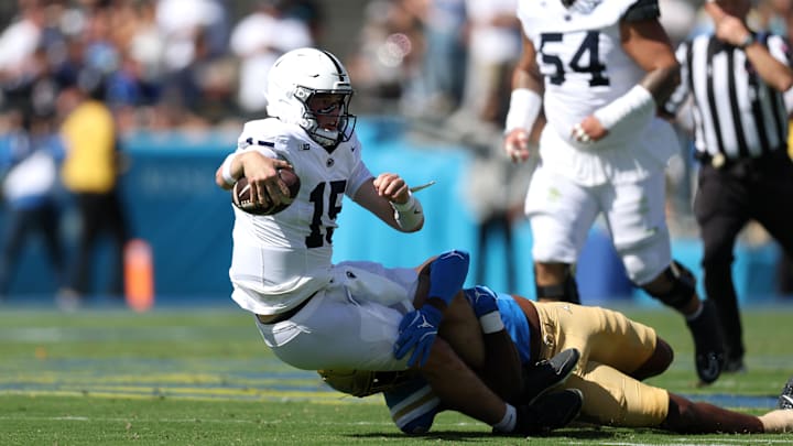 Penn State quarterback Drew Allar is tackled by UCLA linebacker Jonjon Vaughns. Penn State quarterback Drew Allar is tackled by UCLA linebacker Jonjon Vaughns.