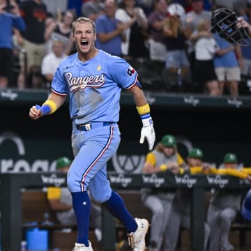 Sep 1, 2024; Arlington, Texas, USA; Texas Rangers third baseman Josh Jung (6) celebrates after he hits a game winning three run walk-off home run during the tenth inning off of Oakland Athletics relief pitcher Mason Miller (19) at Globe Life Field.