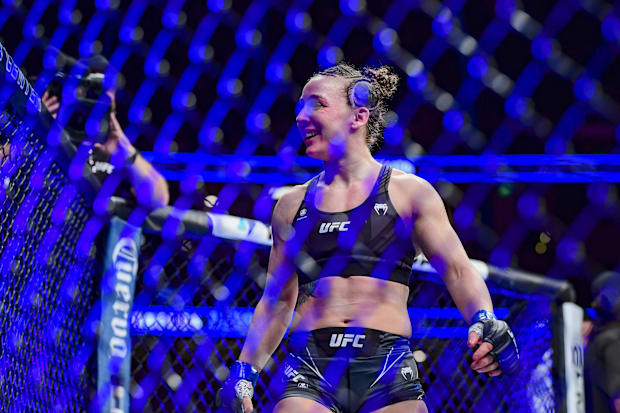Vanessa Demopoulos (blue gloves) reacts to her win by submission over Silvana Gomez Juarez (red gloves) during UFC 270.